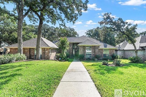 A house with a lawn and a walkway in front.