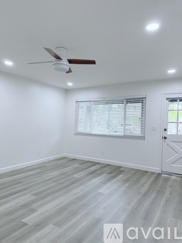 A room with a ceiling fan and lighting fixtures.