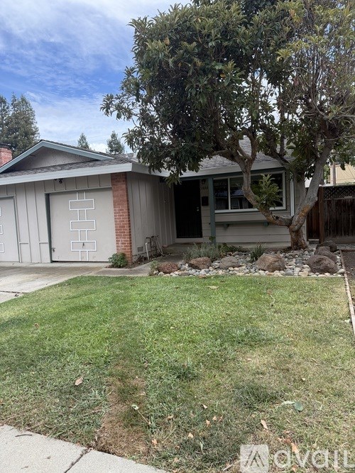 A house with a tree in front of it.