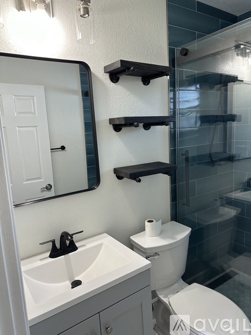 A white toilet sits next to a sink in a bathroom.