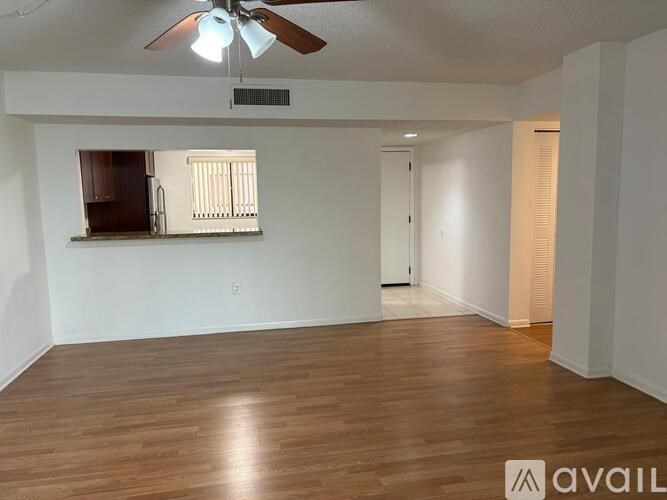 A room with wooden flooring and a ceiling fan.