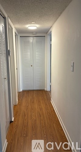 A balcony with a black railing and tiled floor.