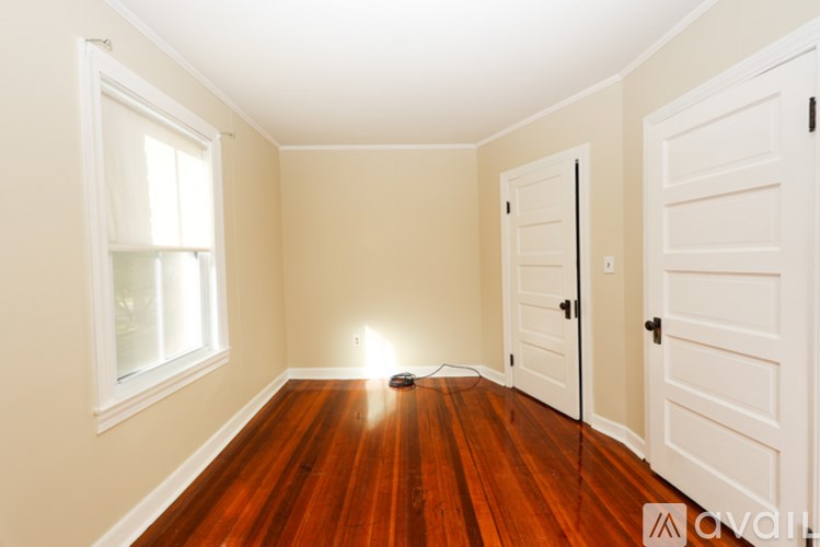 A room with wooden floors and white walls.