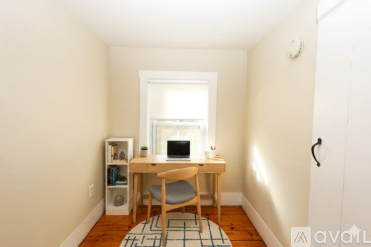 A room with a desk and a chair.