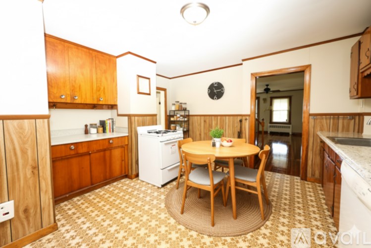 A kitchen with a table and chairs in the middle of the room.