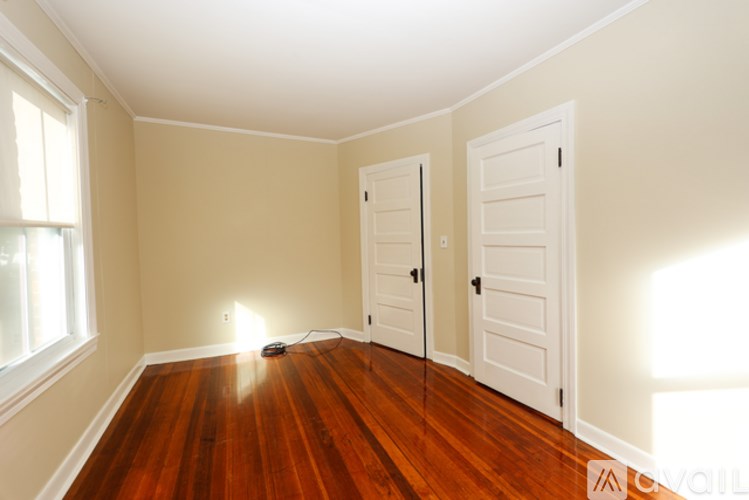 A room with wood floors and white walls.