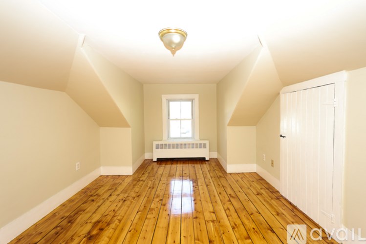 A room with wooden floors and white walls.