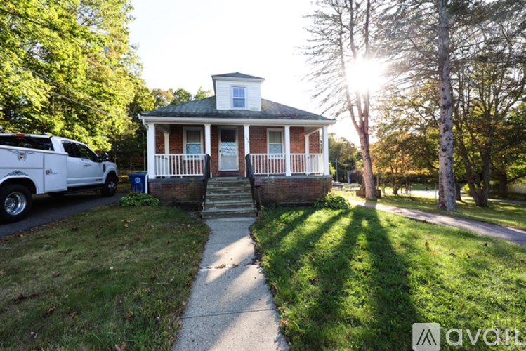 A house with a white car parked in front.