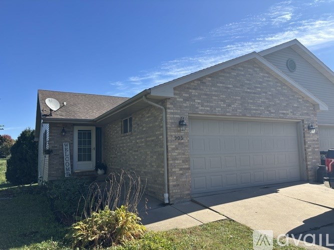 A house with a garage and a driveway in front.