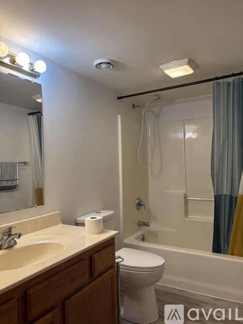 A bathroom with a toilet, sink, and bathtub.