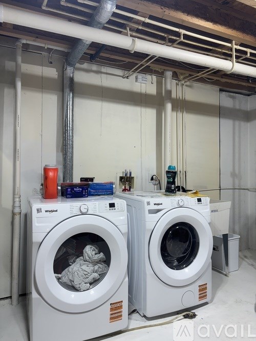Two front loading washing machines in a laundry room.