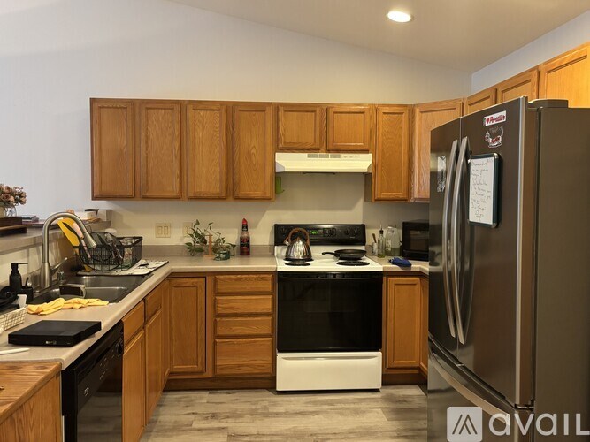 A kitchen with wooden cabinets and a black stove top oven.