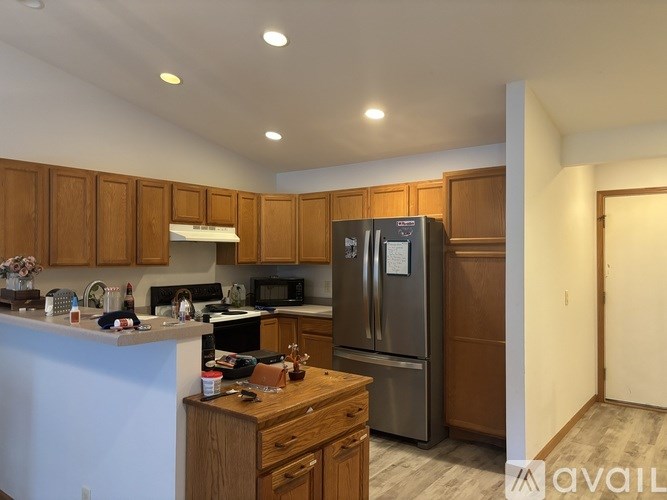 A kitchen with wooden cabinets and stainless steel appliances.