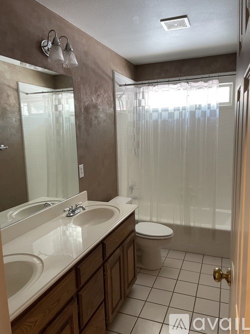 A bathroom with a toilet, sink, and shower.