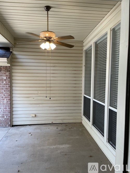 A ceiling fan hangs over a closed garage door.