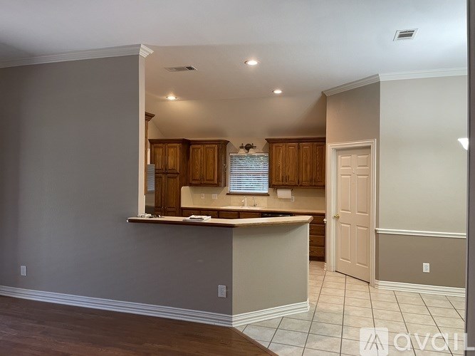 A kitchen with wooden cabinets and a white countertop.