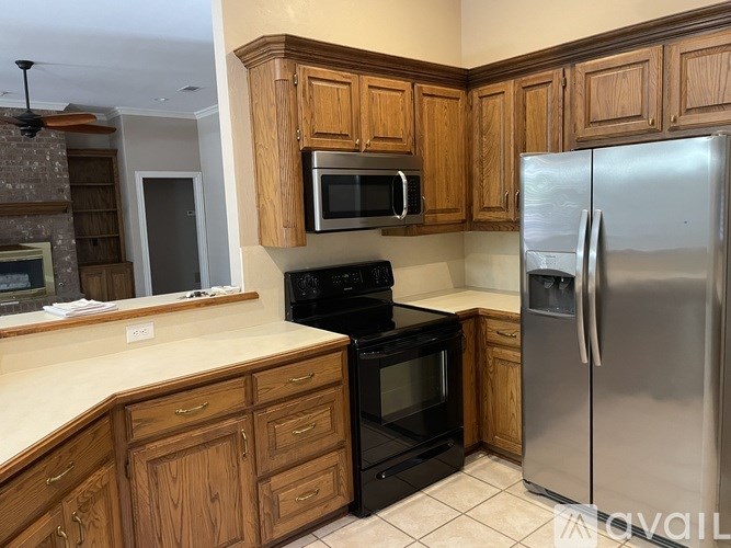 A kitchen with wooden cabinets and a black stove top oven.