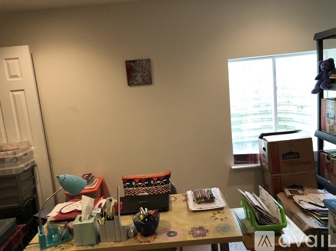 A messy desk with various items scattered about.