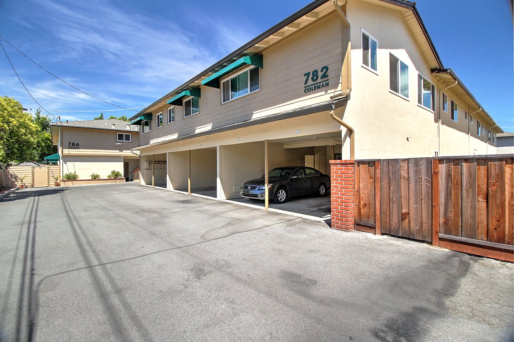 an empty parking lot in front of an apartment building