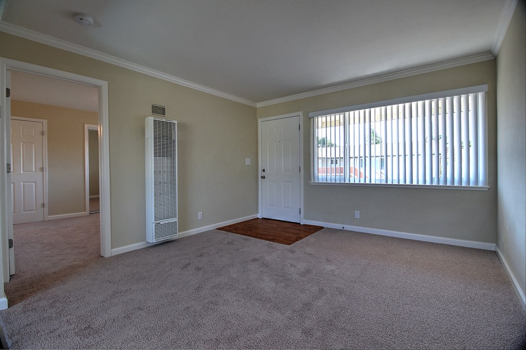 an empty living room with a large window