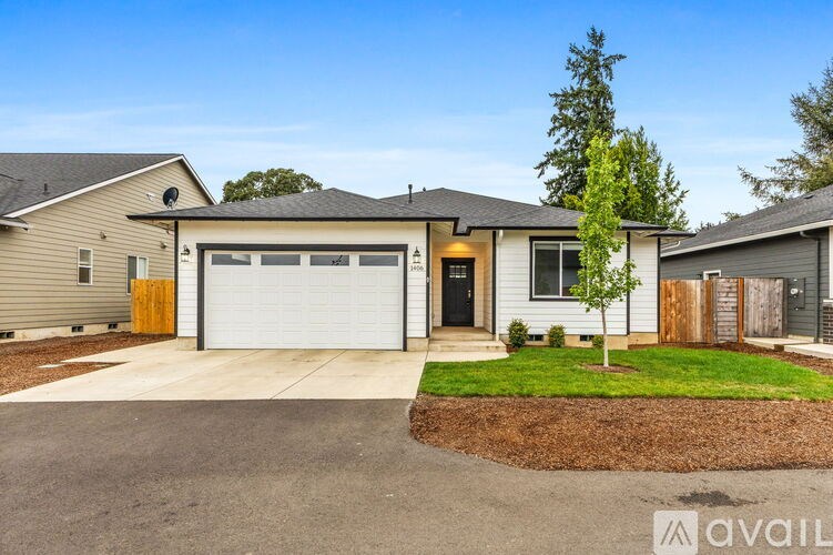 A house with a garage and a driveway in front.