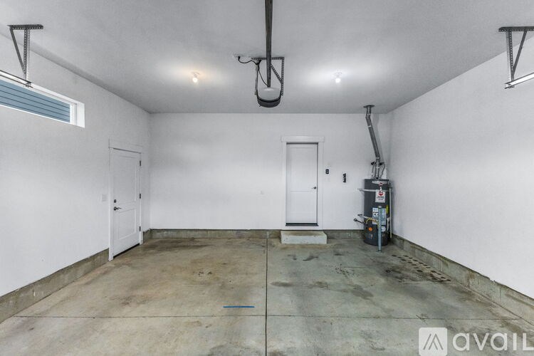 A large empty room with a concrete floor and white walls.