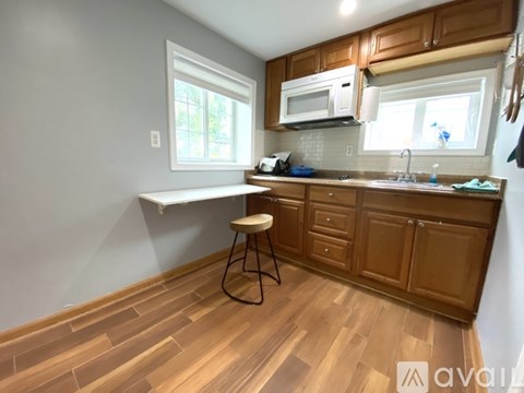 A kitchen with wooden cabinets and a white countertop.