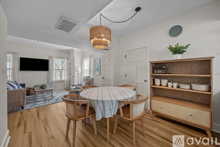A dining room with a wooden table and chairs.