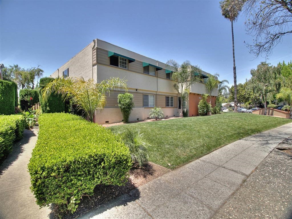 A modern house with a well-maintained lawn and a clear blue sky.