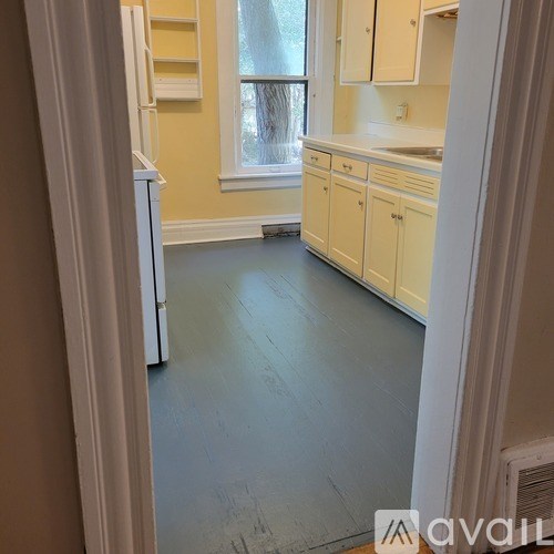 A kitchen with white appliances and cabinets.