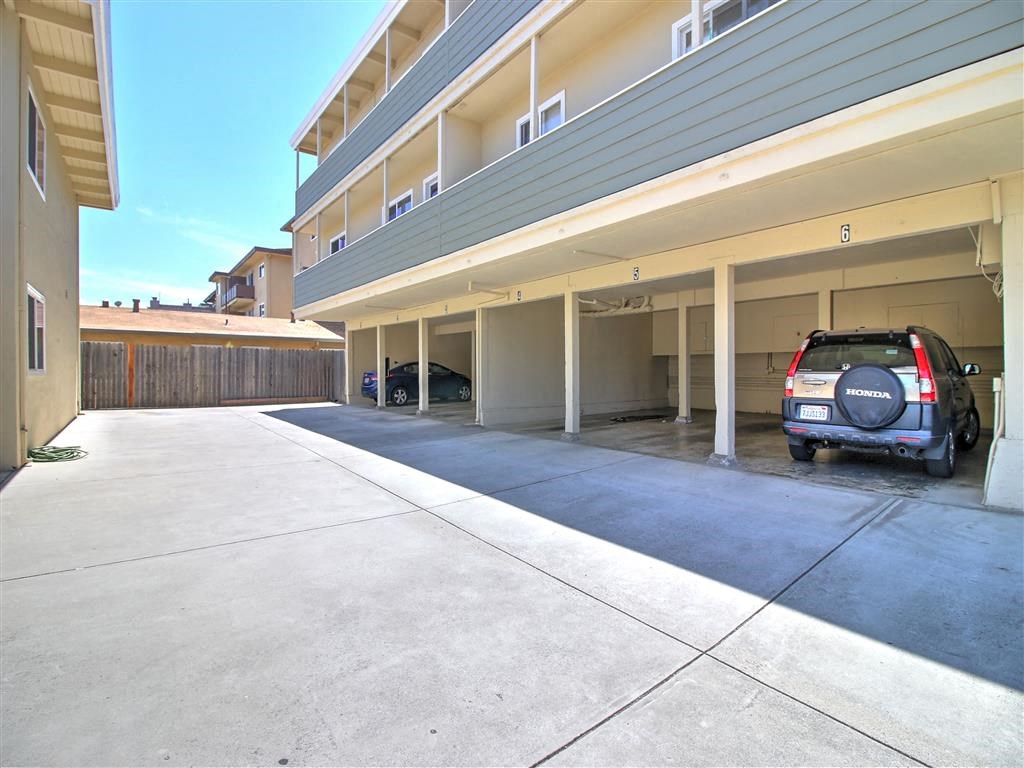 a car parked in a parking garage next to a building