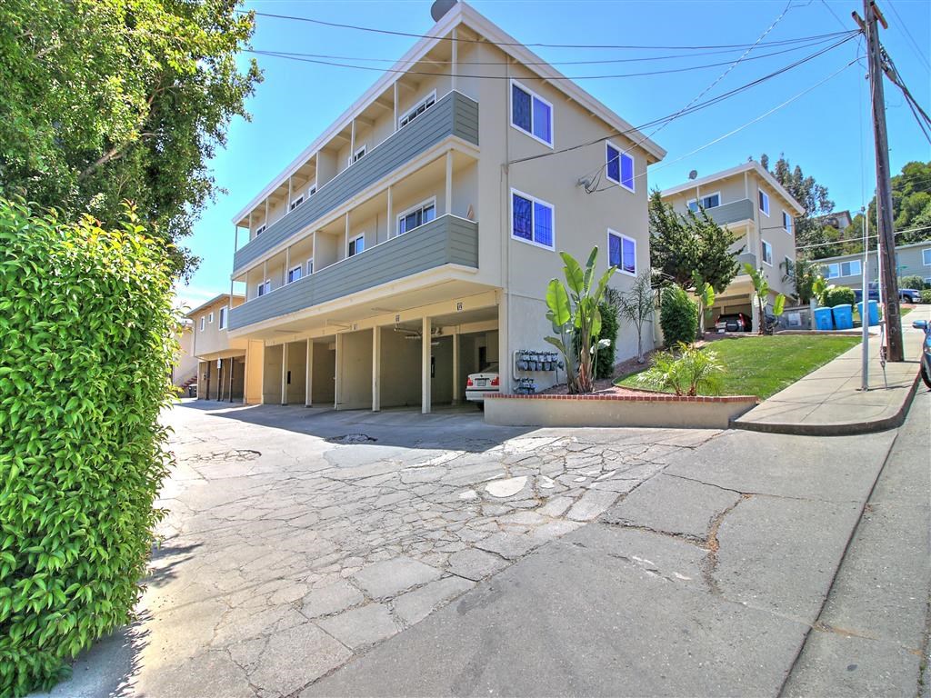 a building with a parking lot and a street in front of it