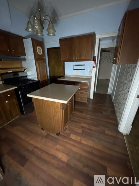 A kitchen with wooden cabinets and a stove top oven.