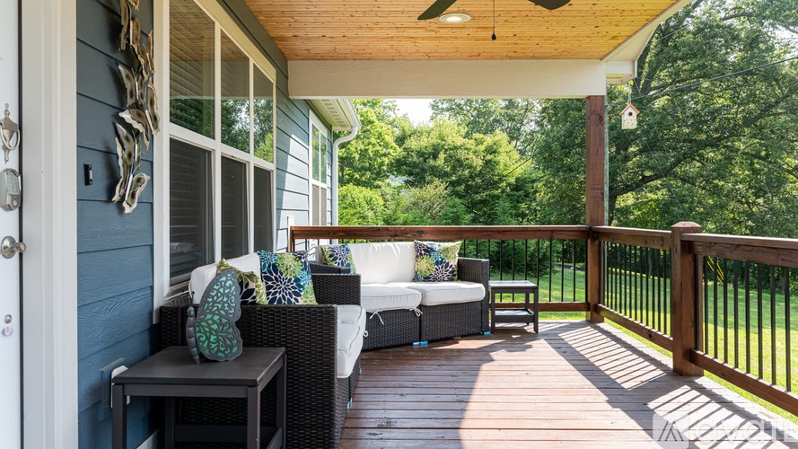 A patio with a couch and a table.