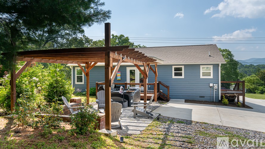 A house with a covered patio and a mountain in the background.