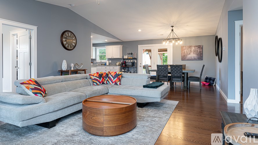 A living room with a grey couch and a wooden coffee table.