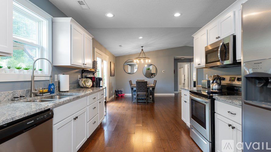 A kitchen with white cabinets and stainless steel appliances.