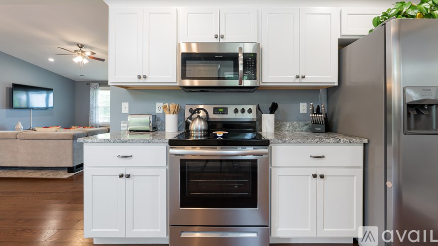 A kitchen with white cabinets and stainless steel appliances.