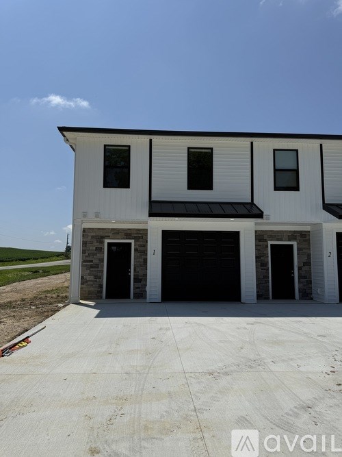 A two-story house with a garage is available for purchase.