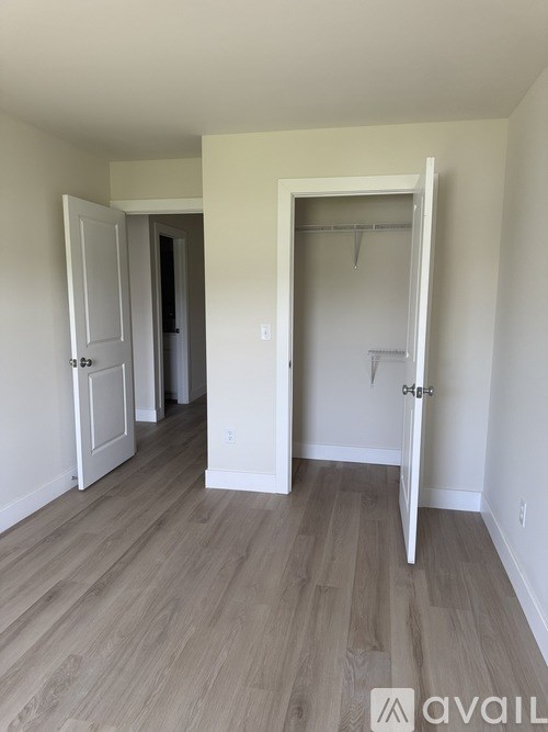 A room with a door and a white wall.