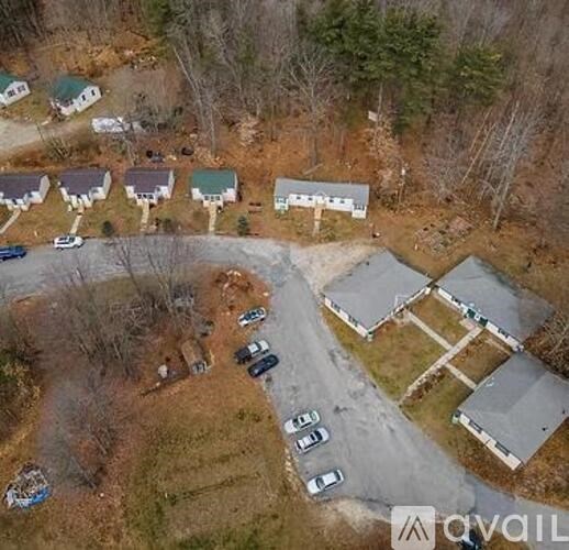 A bird's eye view of a residential area with houses and cars.