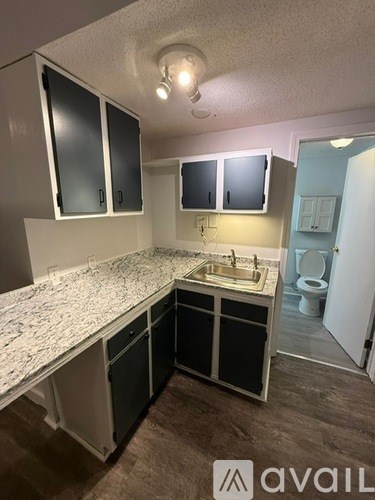 A room with wooden flooring and a window.