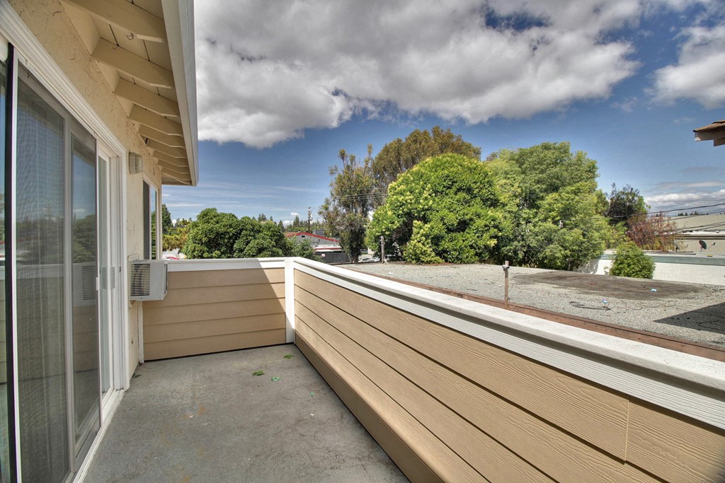 the view from the balcony of a home with a large deck
