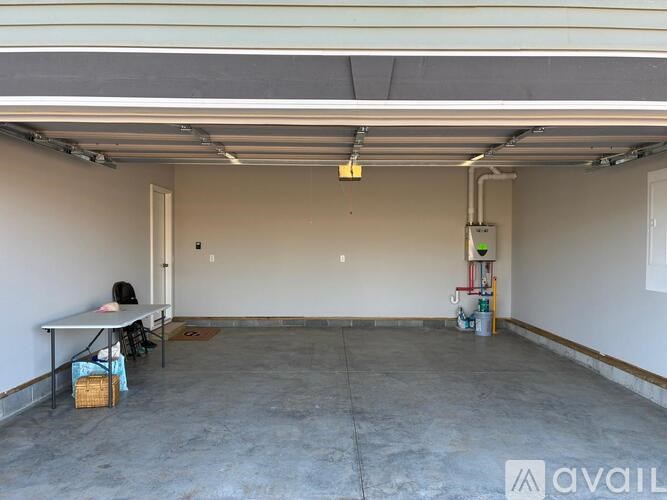 A spacious garage with a table and chairs in the corner.