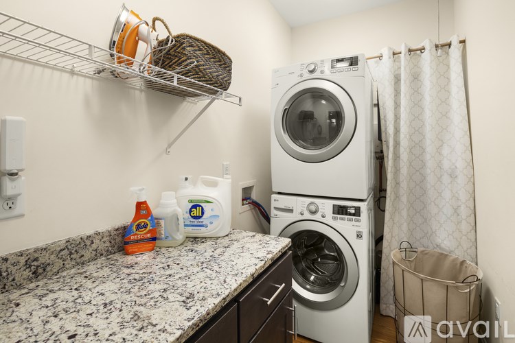 A laundry room with a washer and dryer stacked on top of each other.