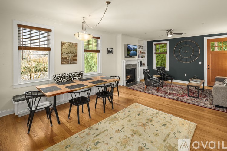 A living room with a dining table and chairs.
