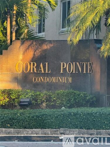 A sign that says Coral Pointe Condominium is on a wall.