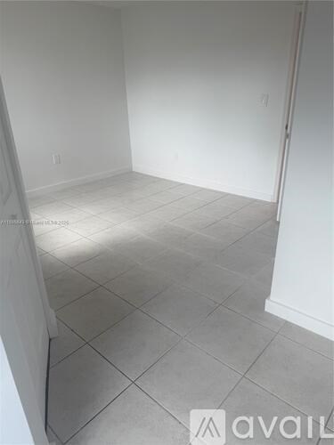 A room with white walls and a tiled floor.