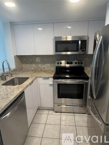 A kitchen with a stove top oven and a microwave above it.