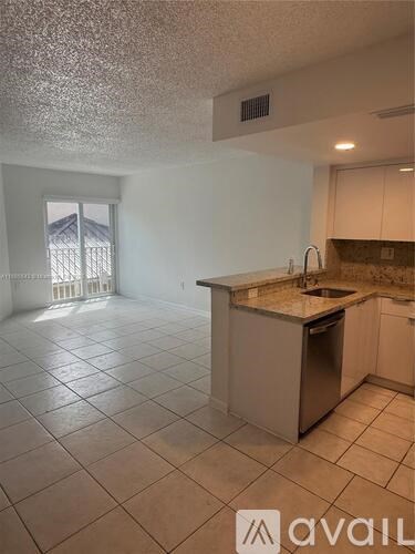 A kitchen with a sink and a window.